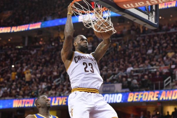 Jun 8, 2016; Cleveland, OH, USA; Cleveland Cavaliers forward LeBron James (23) dunks the ball in front of Golden State Warriors forward Draymond Green (23) during the four quarter in game three of the NBA Finals at Quicken Loans Arena. Mandatory Credit: Ken Blaze-USA TODAY Sports