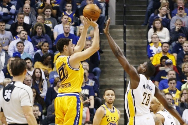 Dec 8, 2015; Indianapolis, IN, USA; Golden State Warriors guard Klay Thompson (11) takes a shot against Indiana Pacers center Ian Mahinmi (28) at Bankers Life Fieldhouse. Mandatory Credit: Brian Spurlock-USA TODAY Sports